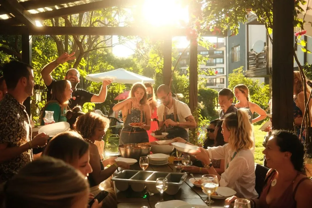 Guests gather for a golden-hour communal dinner at a Casa Basilico pop-up foodie coliving